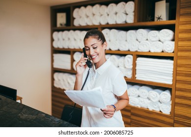 Beautiful Young Woman Working At Hotel In Spa Department And Talking On Phone.