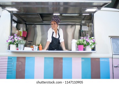 beautiful and young woman working on a food truck - Powered by Shutterstock