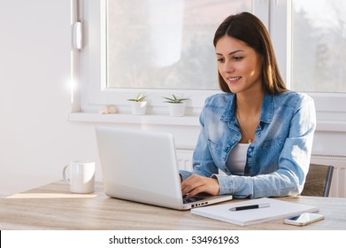 Beautiful Young Woman Working On Her Laptop In Her Office.