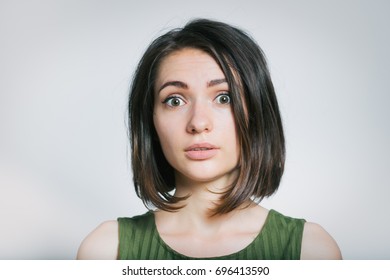 Beautiful young woman worried, confused, isolated on gray background