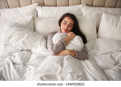 Beautiful Young Woman Wrapped With Soft Blanket Sleeping In Bed At Home, Above View