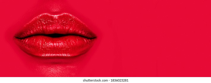 Beautiful young woman's lips closeup, on red background. Make-up concept, lipstick, lip gloss, makeup. Red Lip gloss. Widescreen