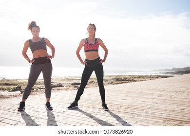 Beautiful Young Women Getting Fit Together Wearing Tights And Crop Tops On A Sunny Day