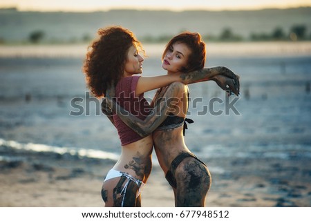 Beautiful young women go out and have fun dirty mud . Girls at the Spa