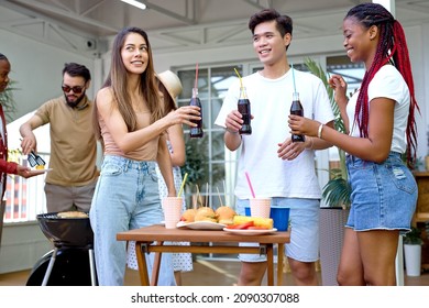 Beautiful Young Women And Men In Casual Summer Clothes Have Fun During Party In Backyard. Group Of Diverse Friends Having An Outdoor Garden Barbecue Laughing With Drinks Beverages, Have Talk