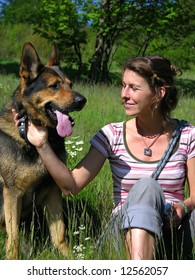 beautifull girl with nice dog in the meadow