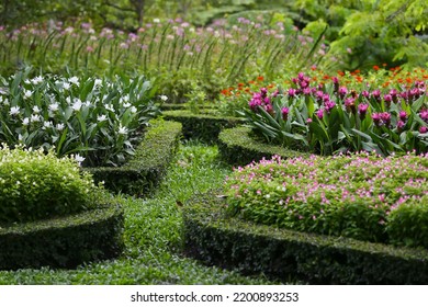 A Beautifully Arranged English Outdoor Flower Garden. Arrange Flowers In Separate Groups, Leaving Space For Walking.