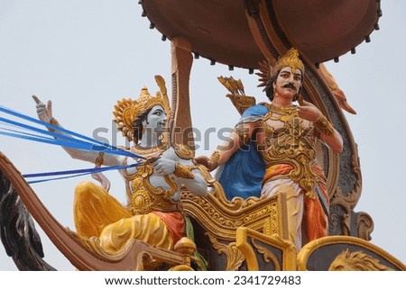 A beautifully colored sculpture showing Shri Krishna as a charioteer preaching to Arjuna during the Mahabharata war. Different angles and focus. Triveni Ghat. Rishikesh. Uttarakhand. India