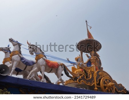 A beautifully colored sculpture showing Shri Krishna as a charioteer preaching to Arjuna during the Mahabharata war. Different angles and focus. Triveni Ghat. Rishikesh. Uttarakhand. India