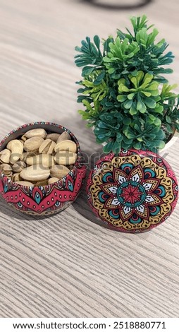 A beautifully crafted small pot decorated with vibrant Pakistani truck art, displaying intricate designs and vivid colors. A perfect accent piece to infuse cultural elegance and artistic expression in