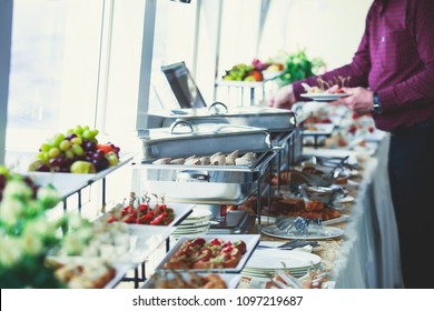 Beautifully Decorated Catering Banquet Table With Variety Of Different Food Snacks And Appetizers On Corporate Christmas Birthday Party Event Or Wedding Celebration
