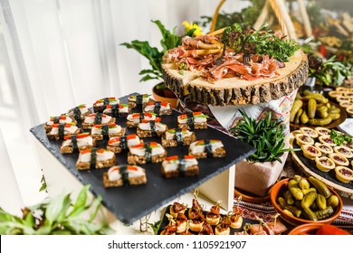 Beautifully Decorated Catering Banquet Table With Different Food Snacks And Appetizers On Corporate Christmas Birthday Party Event Or Wedding Celebration