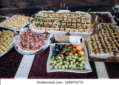 Beautifully Decorated Catering Banquet Table With Different Food Snacks And Appetizers On Corporate Christmas Birthday Party Event Or Wedding Celebration