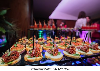 Beautifully Decorated Catering Banquet Table With Different Food Snacks And Appetizers With Sandwich, On Corporate Christmas Party Event Or Wedding Celebration