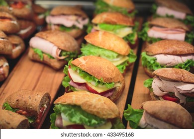 Beautifully Decorated Catering Banquet Table With Different Food Snacks And Appetizers With Sandwich, On Corporate Christmas Birthday Kids Party Event Or Wedding Celebration