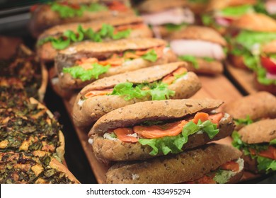 Beautifully Decorated Catering Banquet Table With Different Food Snacks And Appetizers With Sandwich, On Corporate Christmas Birthday Kids Party Event Or Wedding Celebration