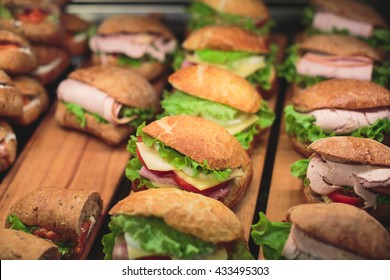 Beautifully Decorated Catering Banquet Table With Different Food Snacks And Appetizers With Sandwich, On Corporate Christmas Birthday Kids Party Event Or Wedding Celebration