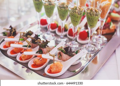 Beautifully decorated catering banquet table with different food snacks and appetizers on corporate christmas birthday party event or wedding celebration
