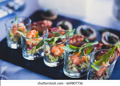 Beautifully decorated catering banquet table with different food snacks and appetizers on corporate christmas birthday party event or wedding celebration
 - Shutterstock ID 669807736