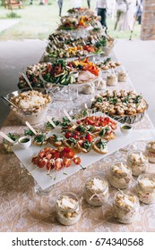 Beautifully Decorated Catering Banquet Table With Different Food Snacks And Appetizers On Corporate Christmas Birthday Party Event Or Wedding Celebration