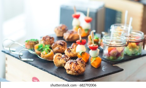 Beautifully Decorated Catering Banquet Table With Different Food Snacks And Appetizers On Corporate Christmas Birthday Party Event Or Wedding Celebration
