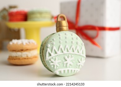 Beautifully Decorated Christmas Macaron On White Table, Closeup