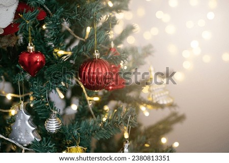 The beautifully decorated Christmas tree and the background lights create a warm, cozy atmosphere
