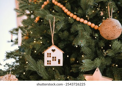 A beautifully decorated Christmas tree features wooden house ornaments and soft lights. The scene captures a cozy holiday atmosphere, perfect for family gatherings and celebrations. - Powered by Shutterstock