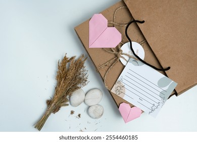 A beautifully decorated gift box with pink origami hearts and dried flowers, perfect for special occasions. The eco-friendly packaging adds an artistic and thoughtful touch to any present. - Powered by Shutterstock