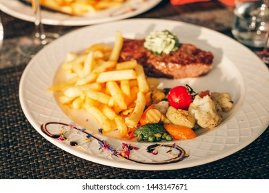 Beautifully Decorated Plate With Steak Café De Paris With Herb Butter And French Fries