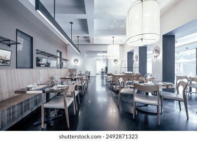 A beautifully designed restaurant interior showcasing a modern and elegant dining area. The space features contemporary furniture, including wooden chairs and tables set with glassware, plates. - Powered by Shutterstock