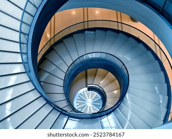 A beautifully designed spiral staircase in a modern building with glass railing - Powered by Shutterstock