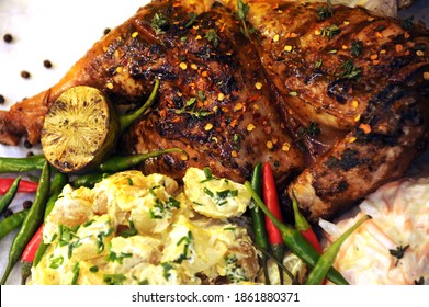 Beautifully Grilled BBQ Chicken With Sides Of Potato Salad And Coleslaw With Roasted Garlic, Lime  And Fresh Chillies 