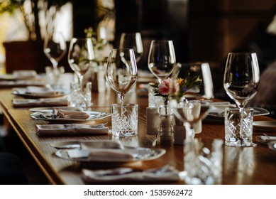 beautifully laid tables with glasses and appliances at morning in restaurant