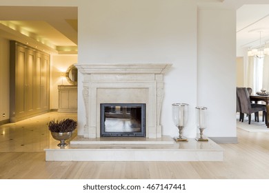 Beautifully moulded fireplace surrounds in classic style, in a very spacious room bordering a vast anteroom