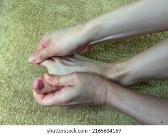 Beautifully Nailed Women's Soles.Asian Woman Massaging Her Own Toes.