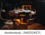 Beautifully organized event - round served table banquet ready for guests, round decorated table with empty plate, glasses, forks, napkin. Elegant dinner table 