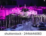 Beautifully organized event - round served table banquet ready for guests, round decorated table with empty plate, glasses, forks, napkin. Elegant dinner table 