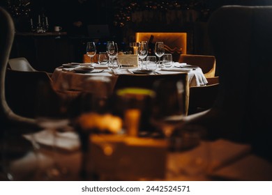 Beautifully organized event - round served table banquet ready for guests, round decorated table with empty plate, glasses, forks, napkin. Elegant dinner table  - Powered by Shutterstock