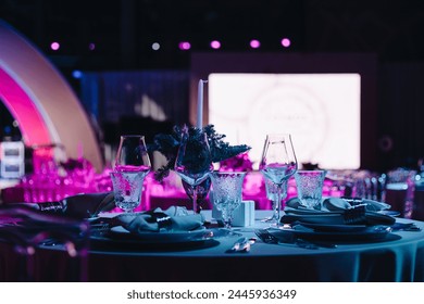 Beautifully organized event - round served table banquet ready for guests, round decorated table with empty plate, glasses, forks, napkin. Elegant dinner table  - Powered by Shutterstock