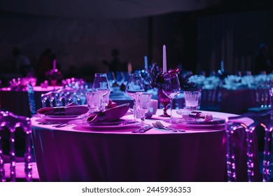 Beautifully organized event - round served table banquet ready for guests, round decorated table with empty plate, glasses, forks, napkin. Elegant dinner table  - Powered by Shutterstock