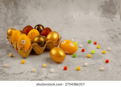 Beautifully painted Easter eggs in an egg basket, decorated with colored sweet jelly beans. Against a dark background.