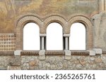 Beautifully painted house facade with Romanesque windows. If required, a beautiful background can be mounted.