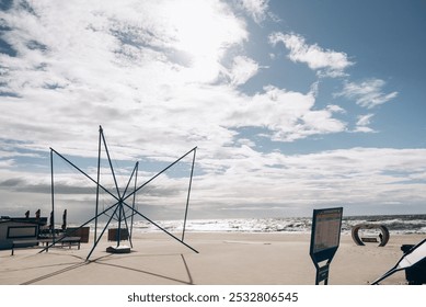 A beautifully scenic beach that features a lifeguard tower along with a lifeguard chair strategically placed for safety oversight - Powered by Shutterstock