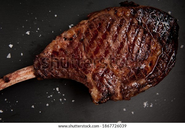 beautifully\
seared tomahawk steak, medium rare to\
rare