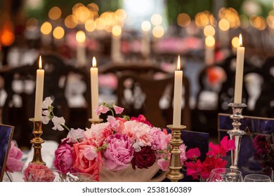 A beautifully set table featuring flickering candlelight and a vibrant floral centerpiece with pink peonies and roses. The soft, romantic glow creates a warm and intimate ambiance. - Powered by Shutterstock