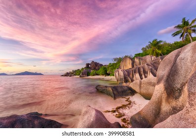 Beautifully shaped granite boulders and a dramatic sunset  at Anse Source d'Argent beach, La Digue island, Seychelles