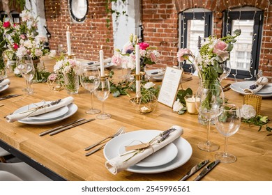 A beautifully styled dinner table setup featuring elegant, minimalist decor. Each place setting includes white plates with linen napkins tied with lavender and a name tag. The table is adorned with gl