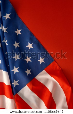 Beautifully waving star and striped American flag on red background