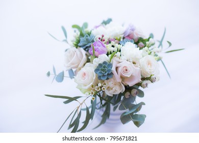 Beautiul spring bridal bouquet with garden roses, carnations, tulips, succulents, waxflower and greenery.